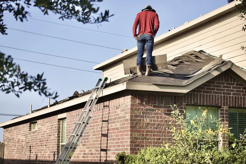 Professional roofer working on a residential roof in Back Bay